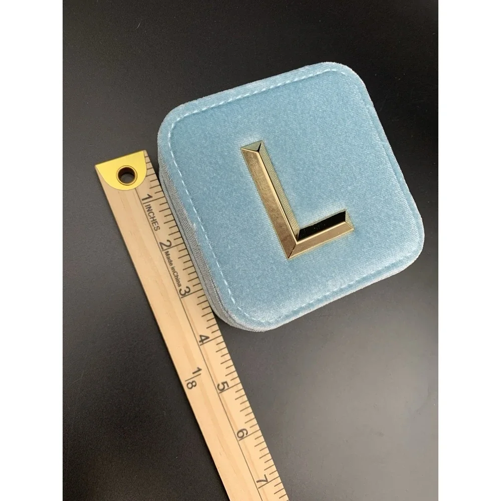 Small blue velvet jewelry box with a zipper